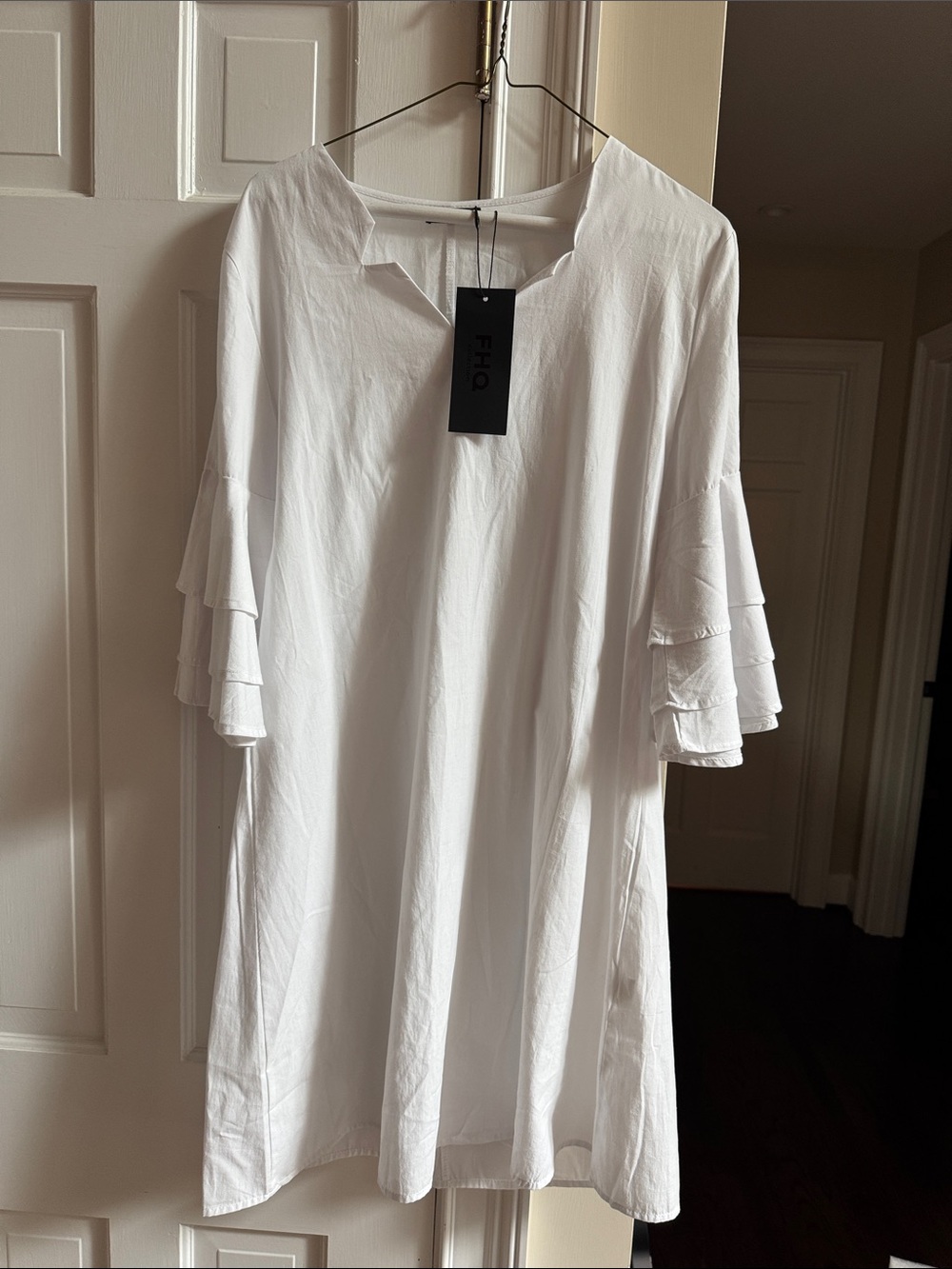 FHQ Collection white loose fitting dress with bell sleeves. Medium